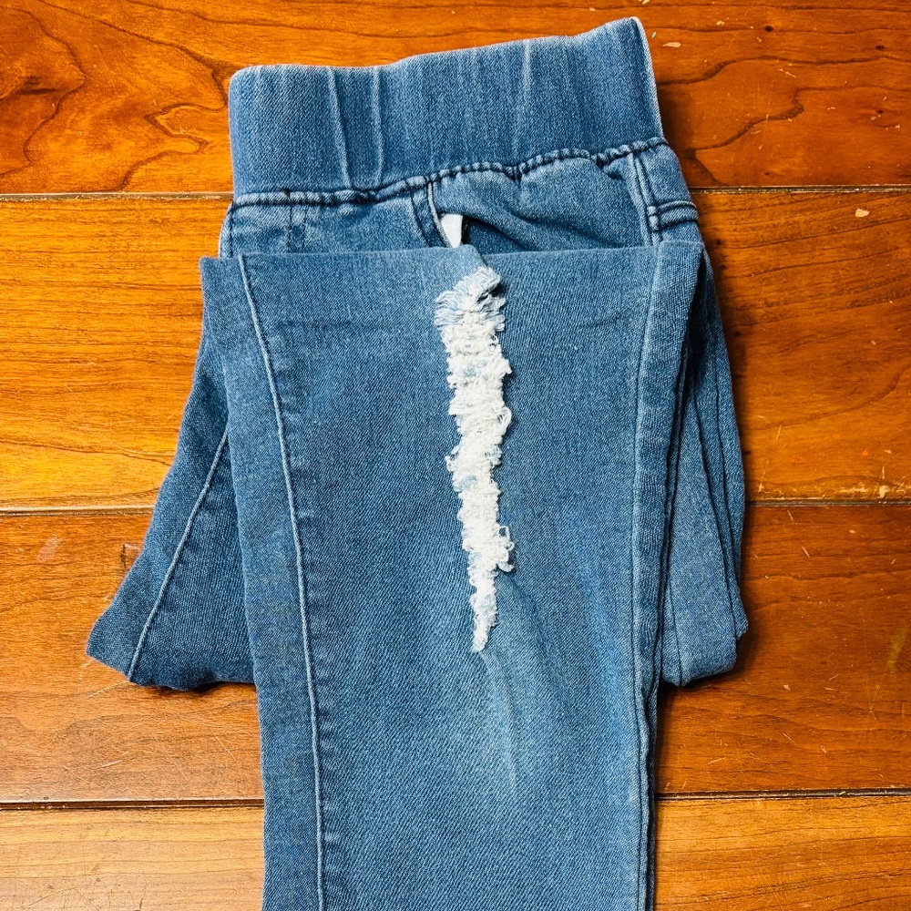 Woman’s ripped jeans